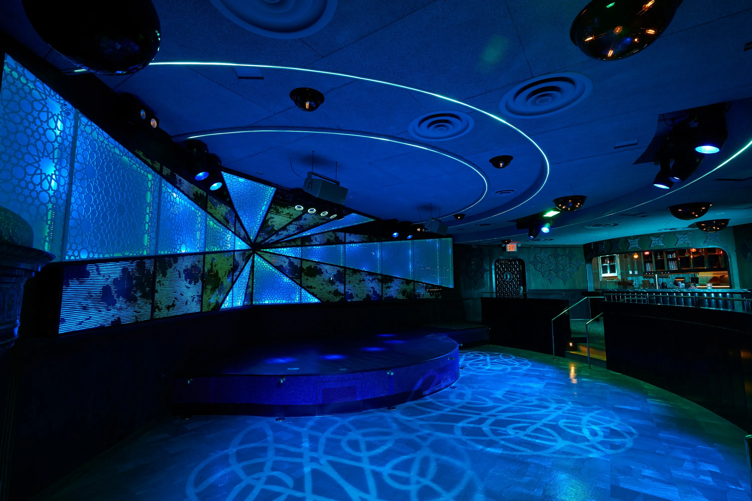 Stage at The Sultan Room with a faceted programmable LED wall glowing blue and white