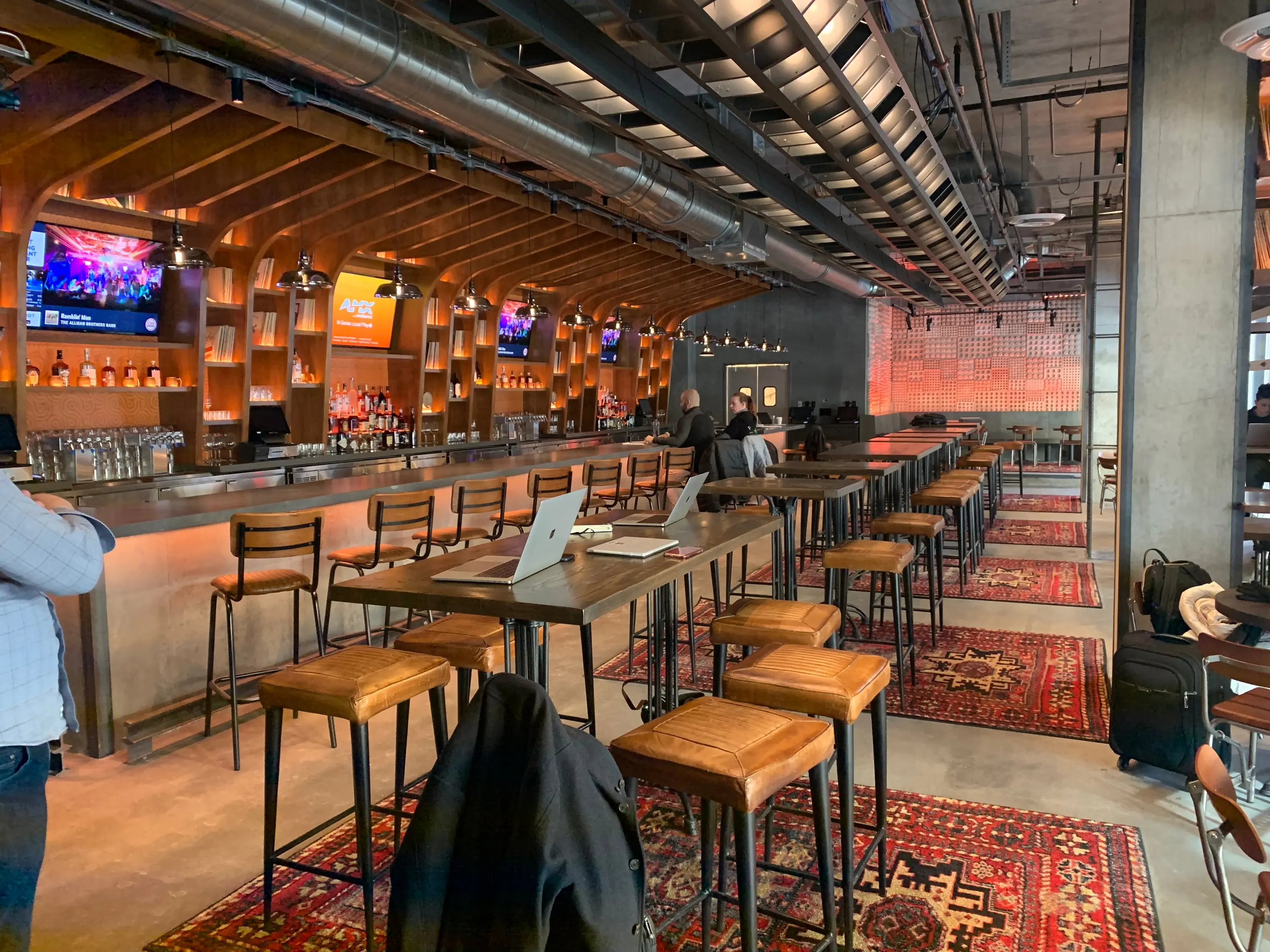 High tables and stools on vintage rugs at Trax