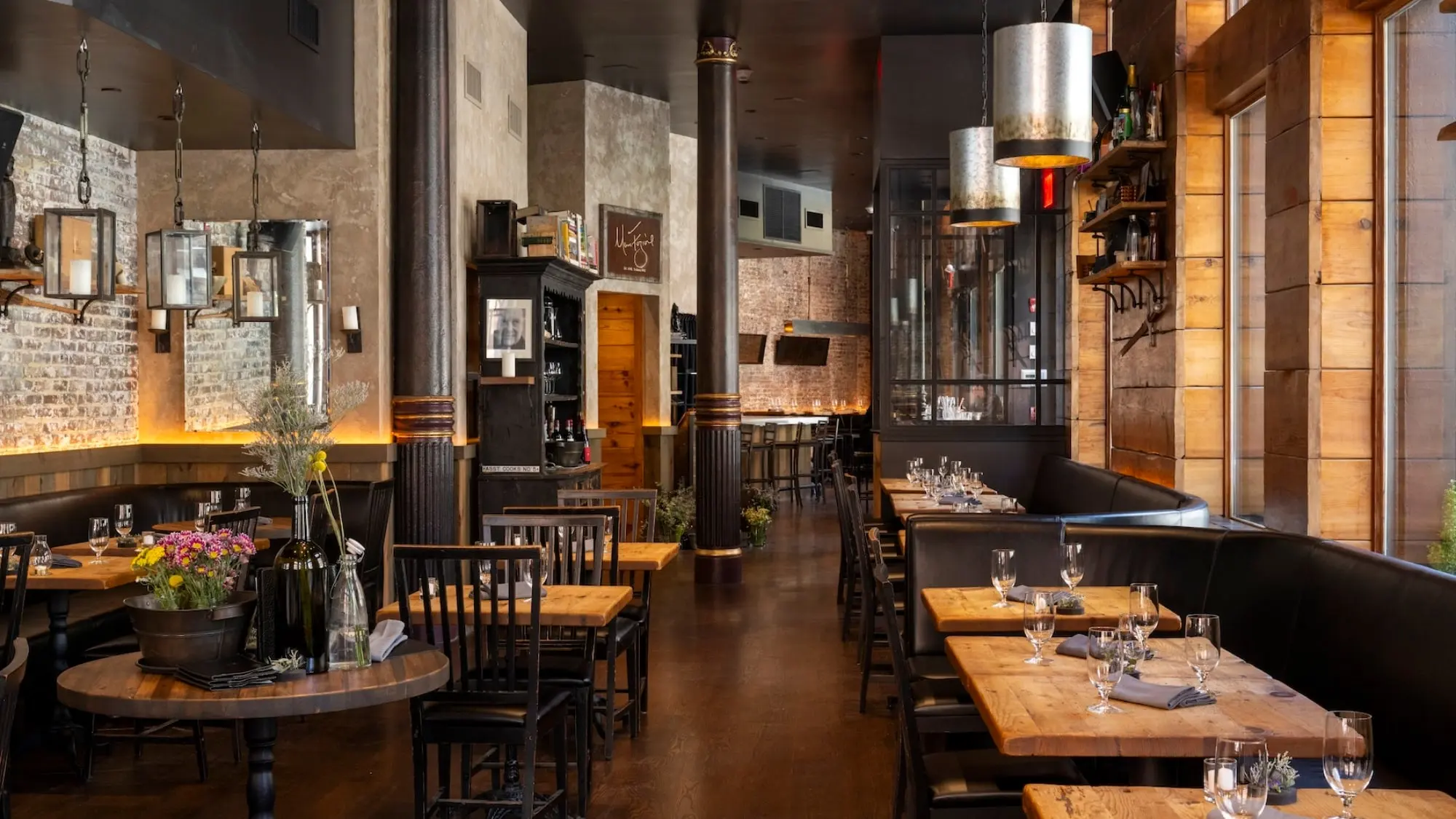 Wide view of the Marc Forgione dining room with exposed brick and pendant lights