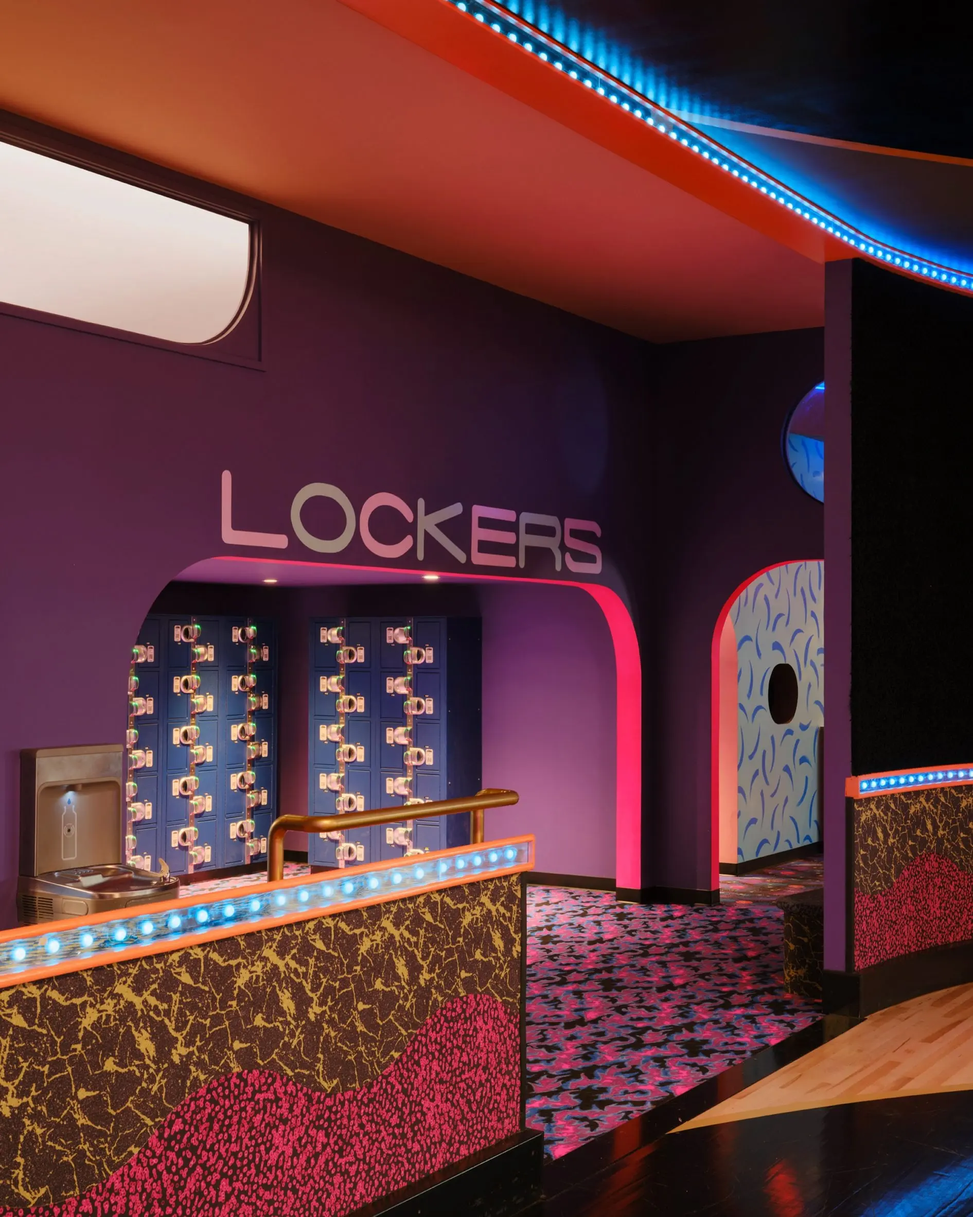 Lockers counter at Xanadu with a red neon-edged sign and terrazzo-patterned front