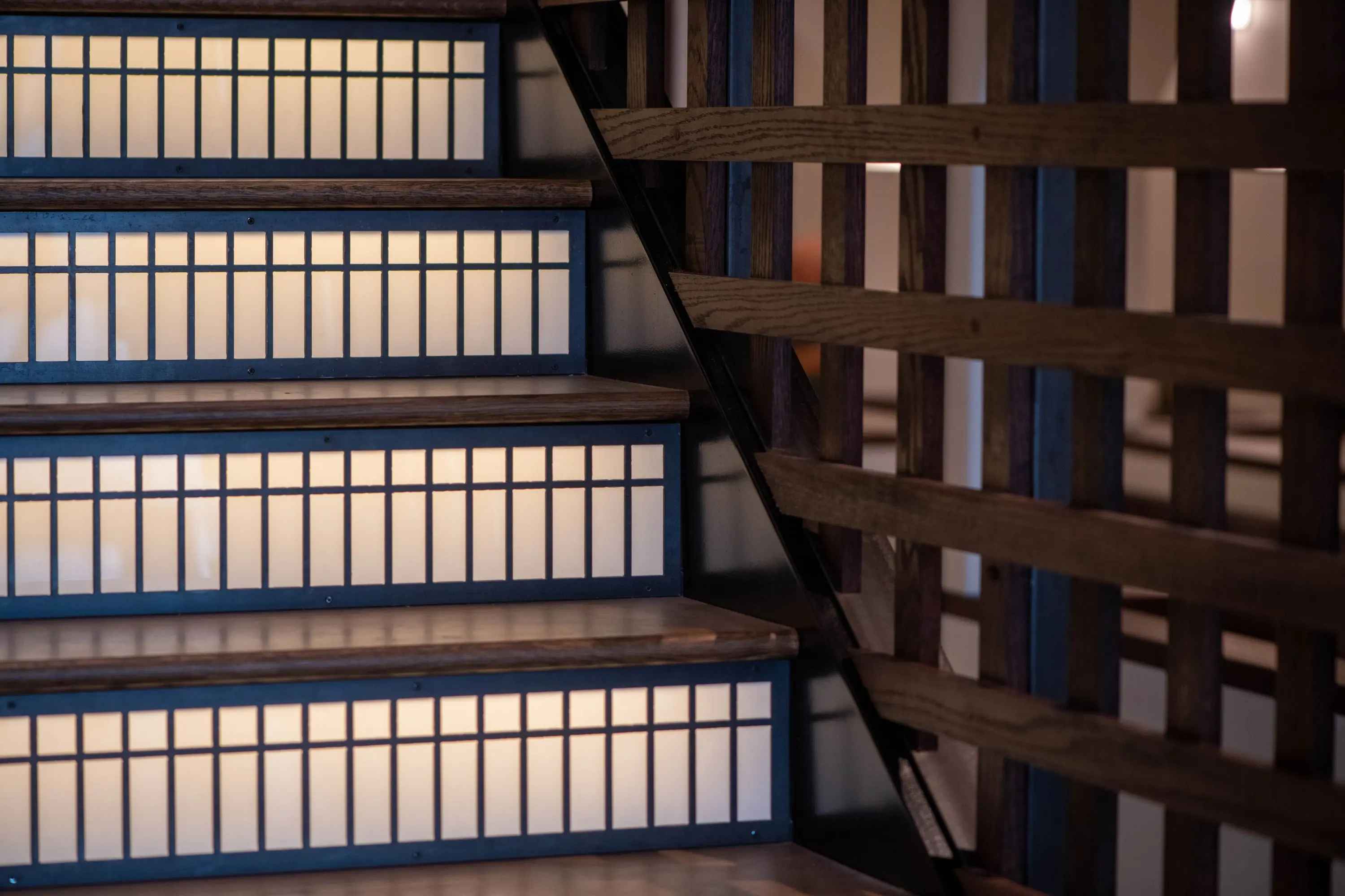 Detail of the timber lattice and blue-painted stair at Eckhart Beer Co