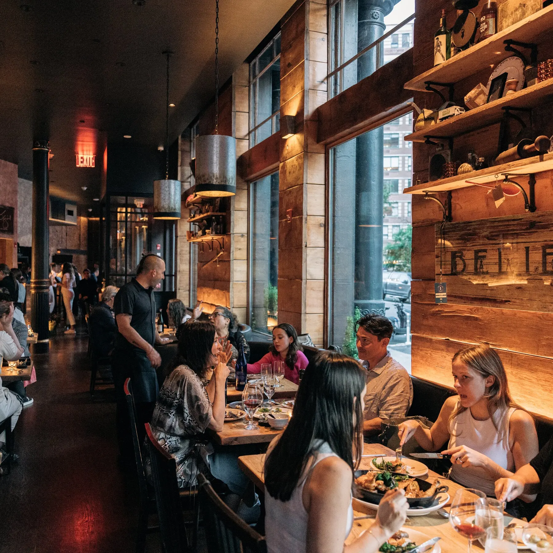 Guests seated at window tables during service at Marc Forgione