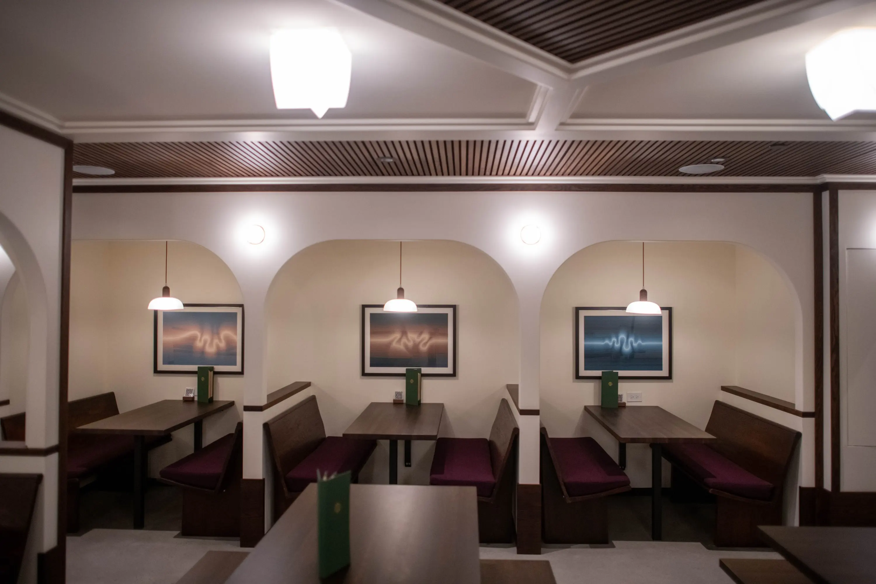 Arched booth seating with pendant lights at Eckhart Beer Co