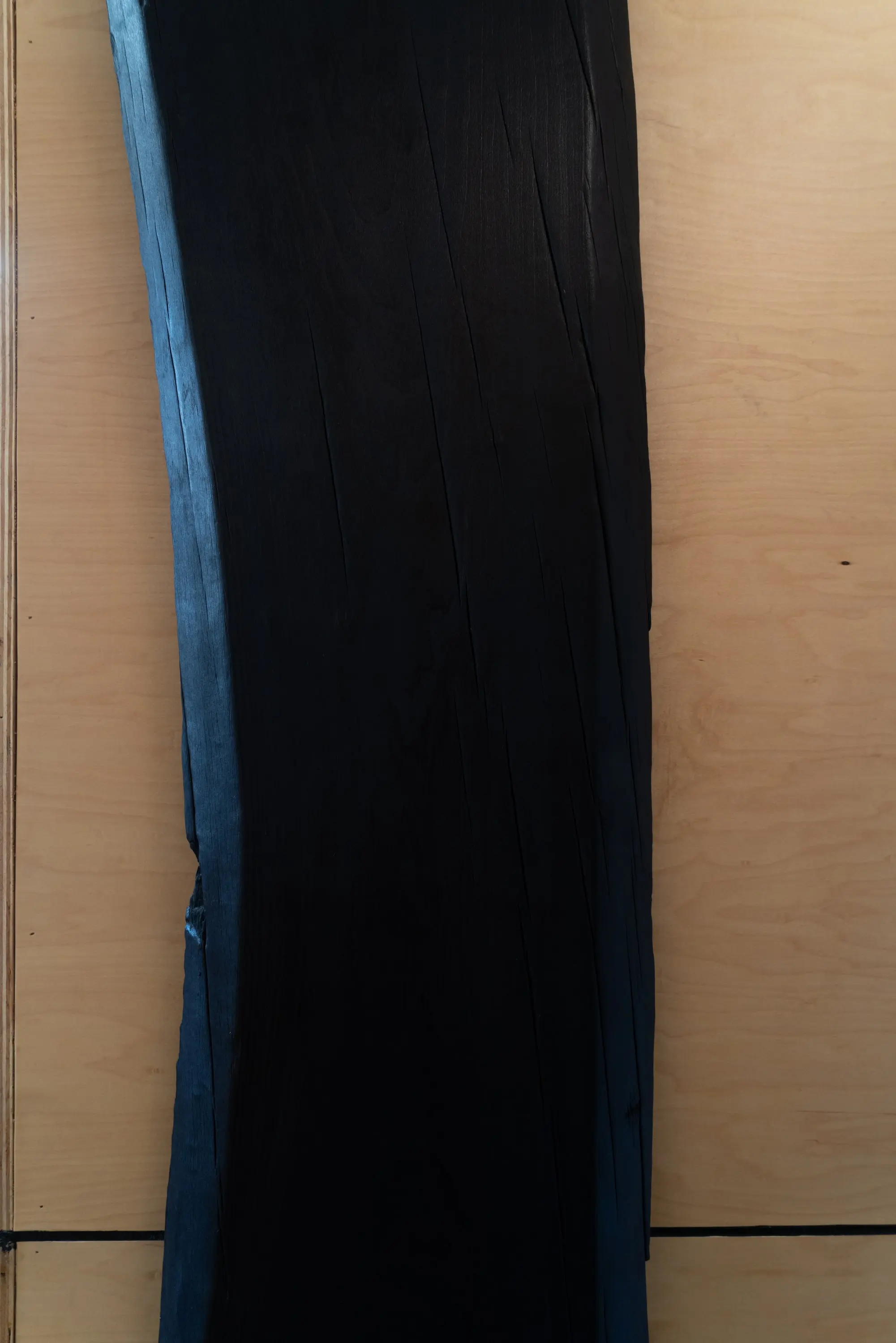 Detail of a charred timber column against birch plywood at KZ_K Studio