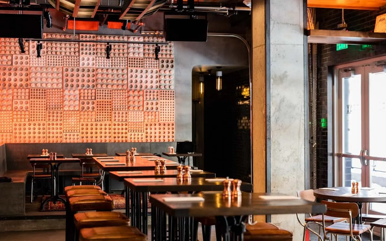 Back bar at Trax with stage lights and screens set into timber casework