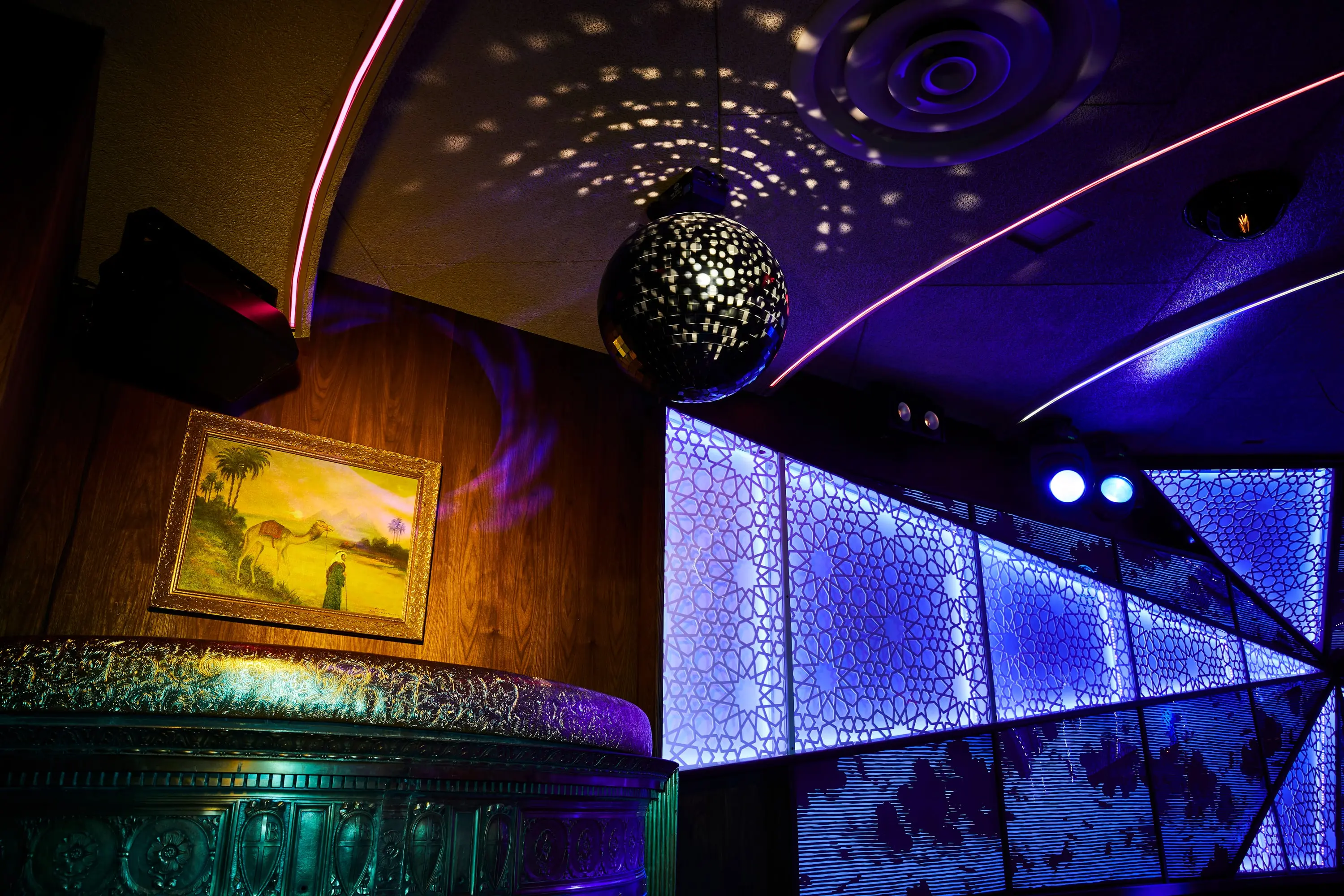 Mirror ball and LED panels casting patterned light across The Sultan Room