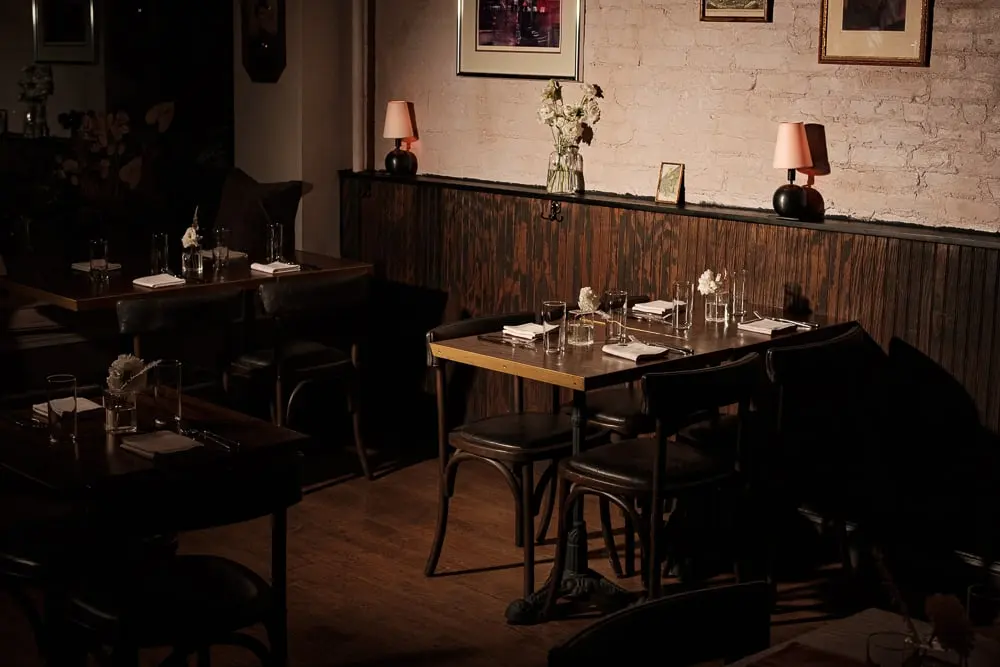 Evening table setting at Clover Hill lit by a small table lamp