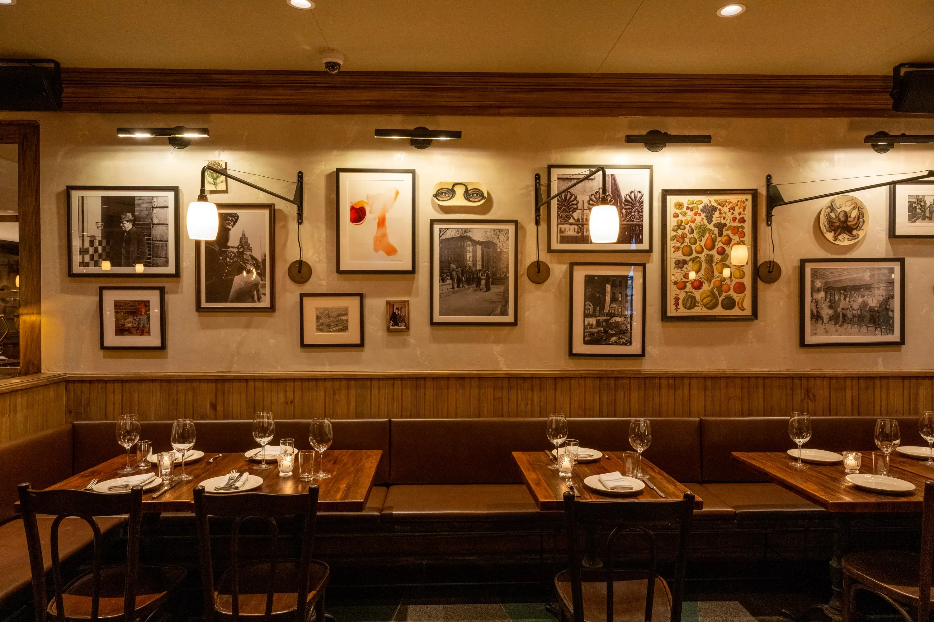 Banquette seating along a gallery wall of framed pictures in the Fountain Room