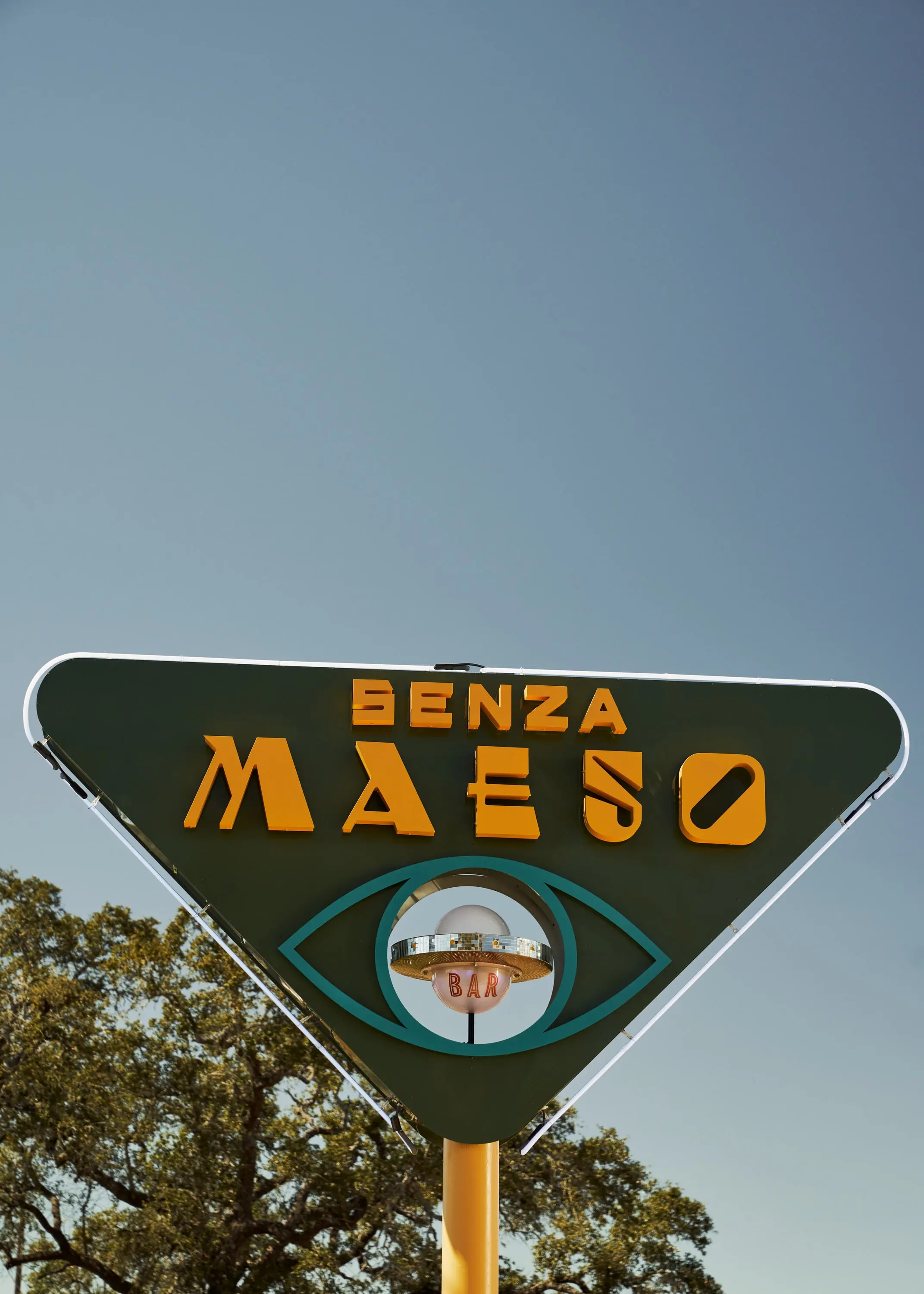 Triangular Senza Maeso road sign with the brand's eye motif