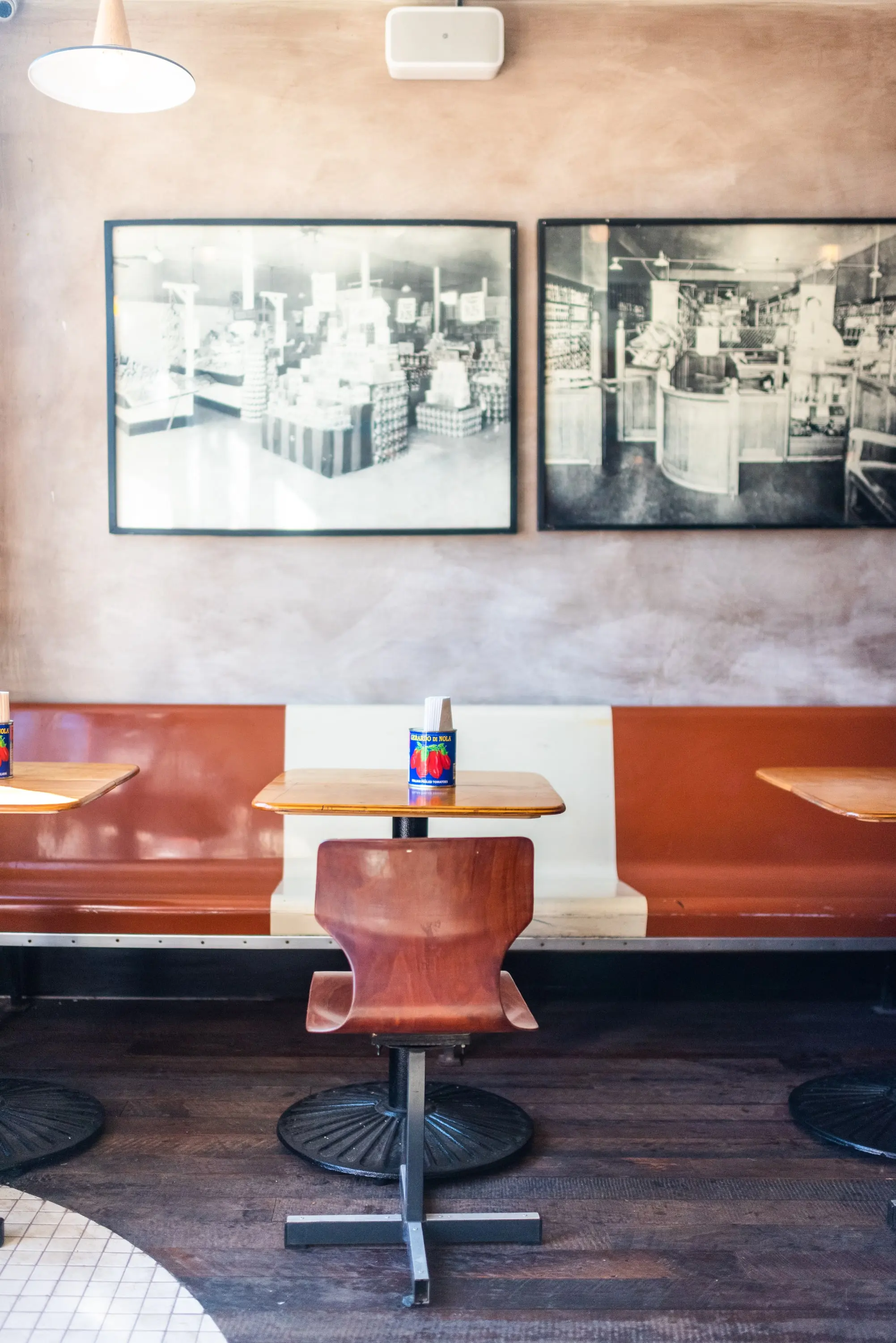 Orange swivel chair and framed photographs at Sonny's Pizza