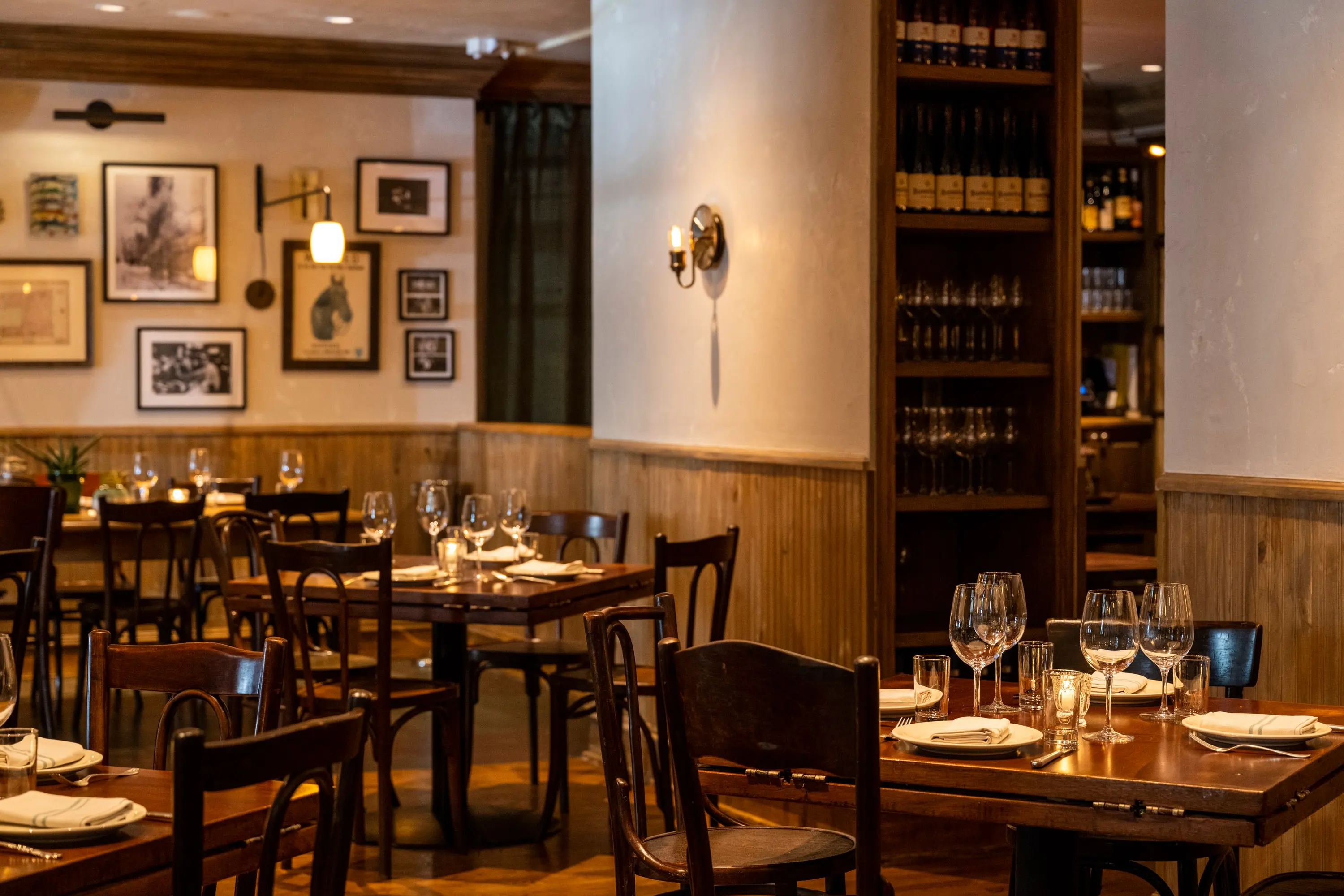 Fountain Room tables with a wine wall in the background at One Fifth