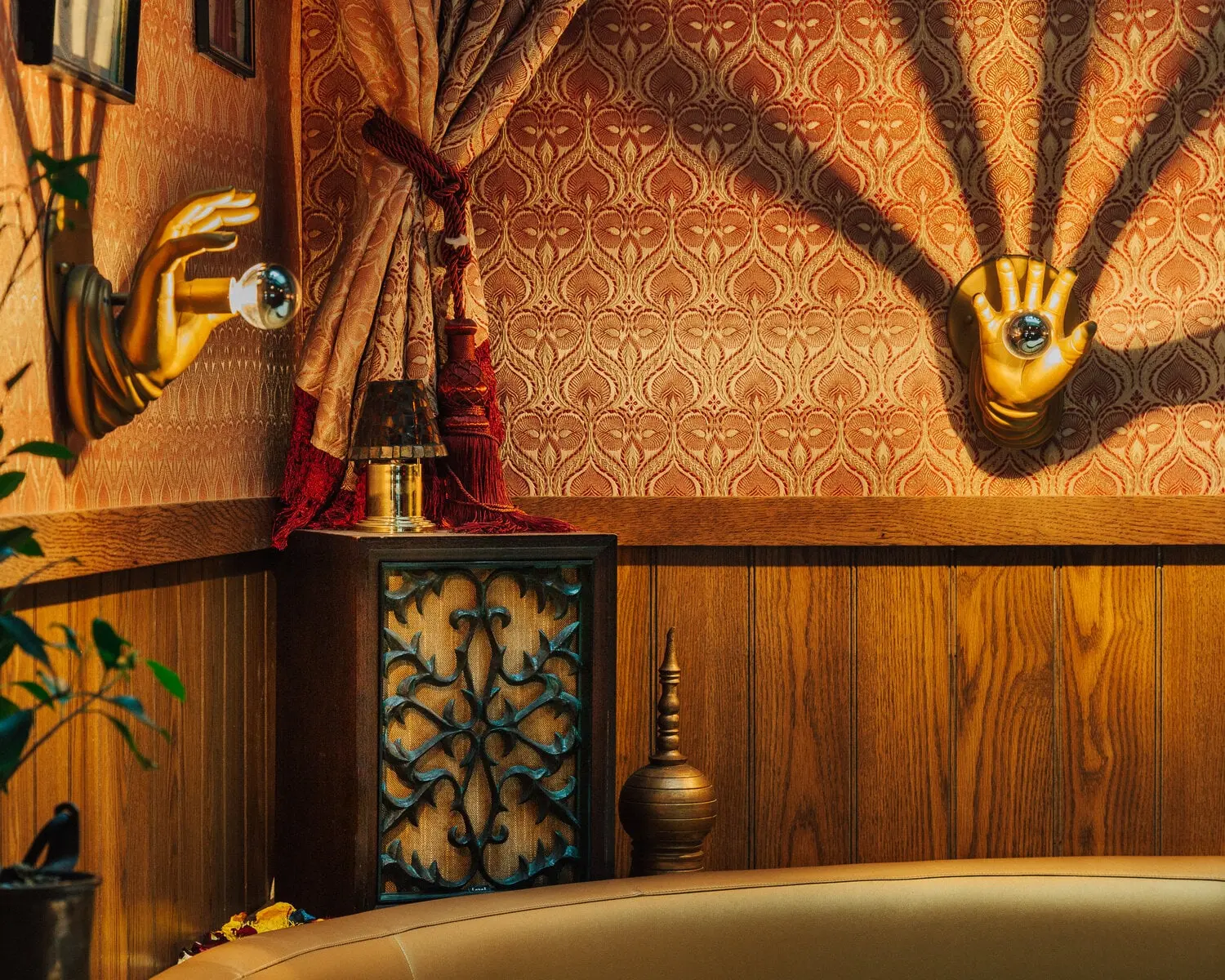 Sconce and ornament against patterned wallpaper at Turk's Inn