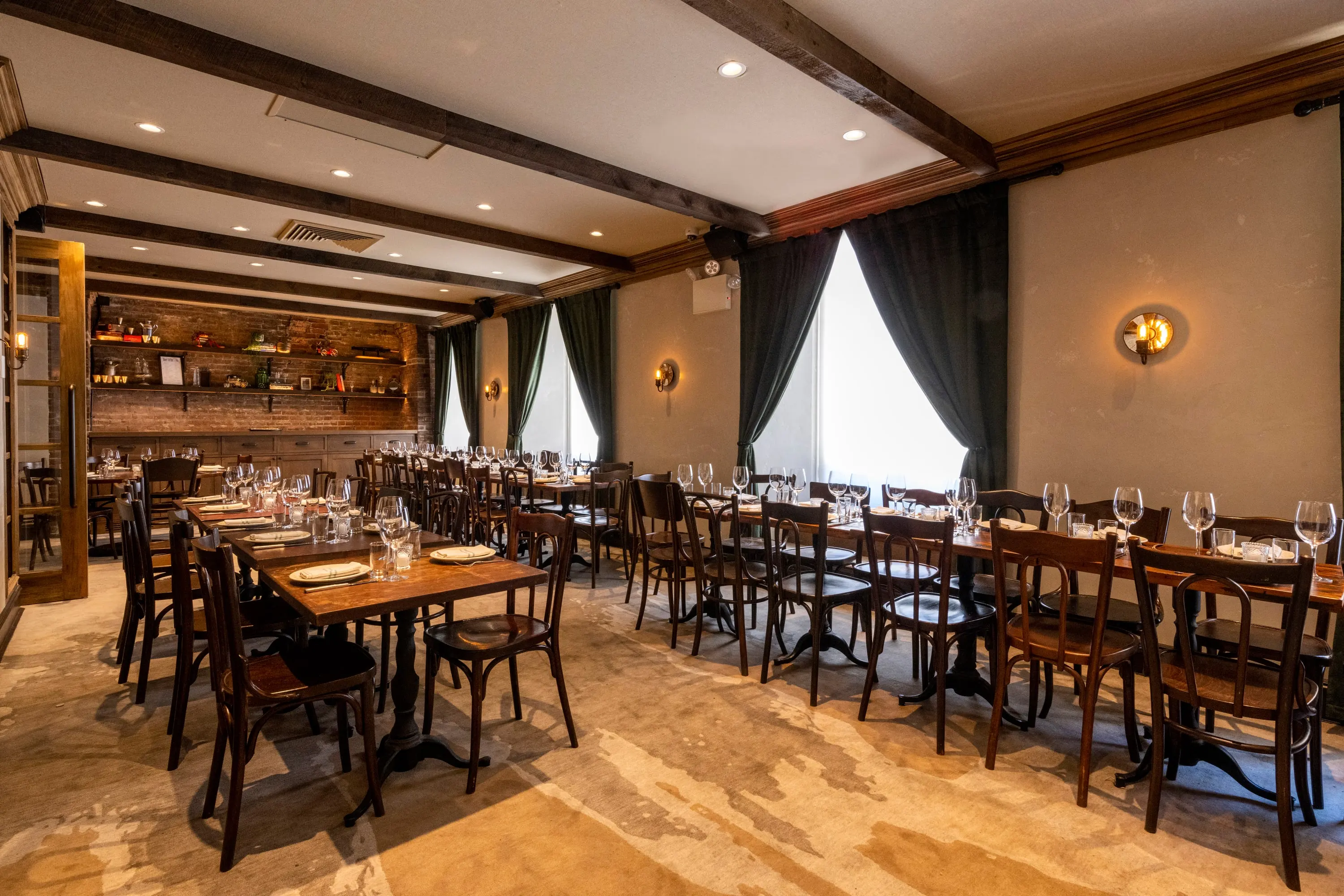 Private dining room at One Fifth with a long table and draped windows